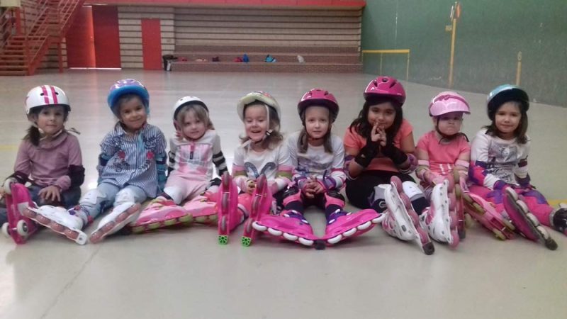 Grupo de patinaje infantil con patines, casco y protecciones